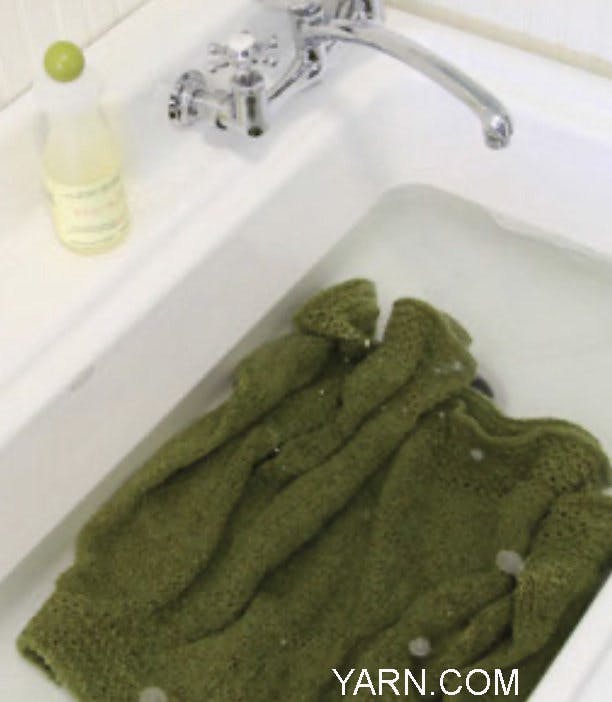 Image of a sweater soaking in a sink