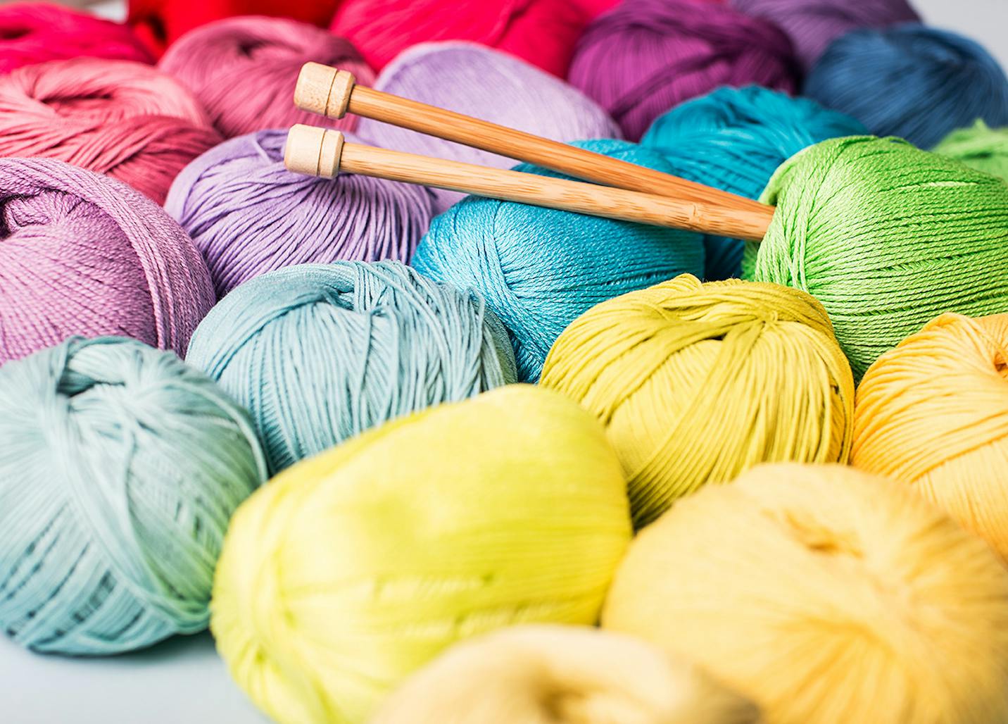 Colorful balls of yarn with knitting needles