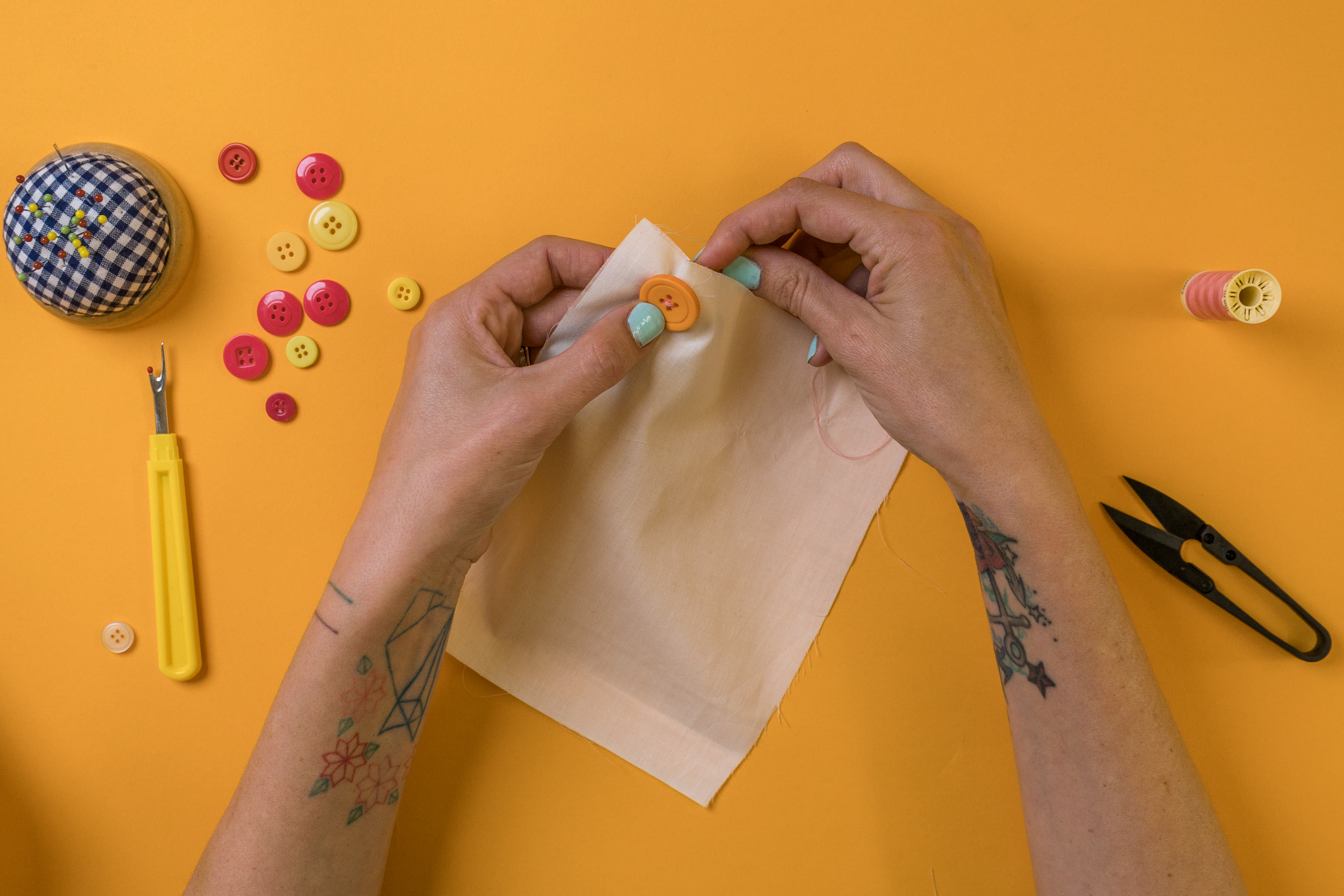 hold the button in place to attach to fabric