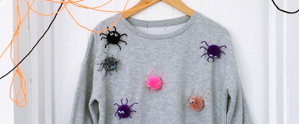 Make a spooky pom pom sweatshirt