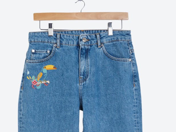 embroidered animal toucan on pair of jeans