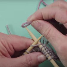 create a loop of yarn to loop over needle and knit in your first colour