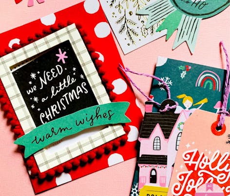 bright, modern card reading "we need a little christmas, warm wishes"