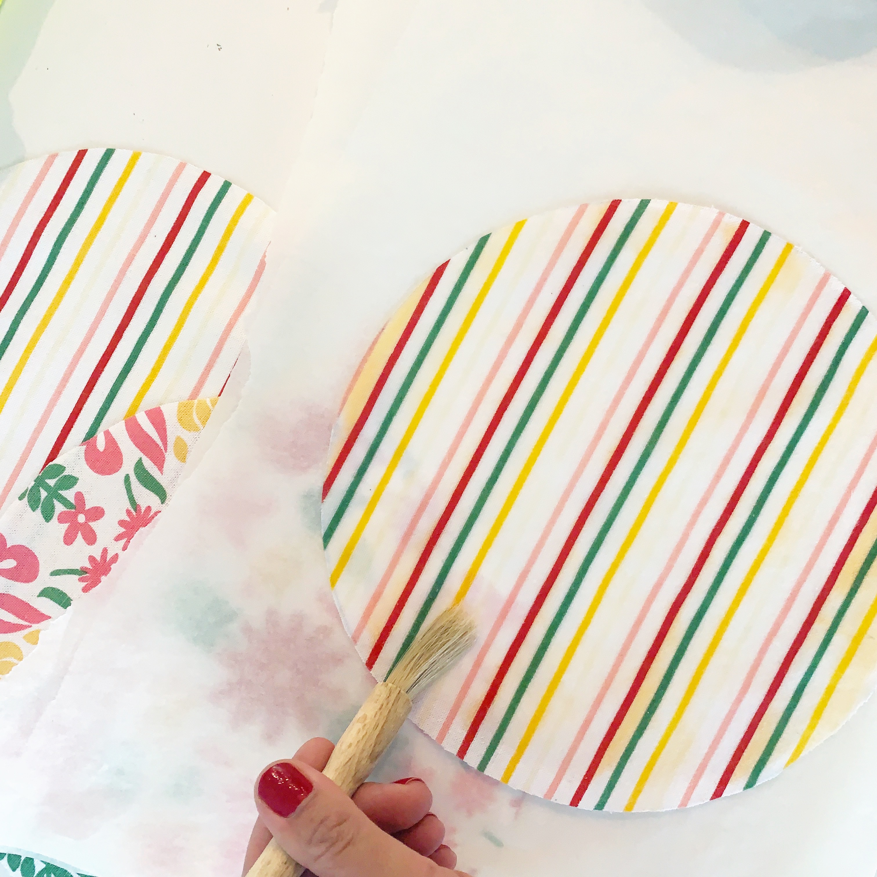 spread the beeswax across fabric with brush