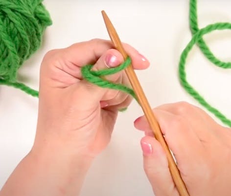 wrap the yarn around your thumb and insert needle under the loop for long tail cast on