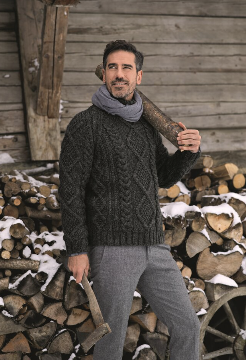 Man wearing a dark green cable knit sweater