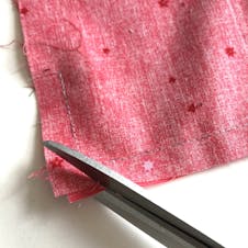 Scissors trimming corner of fabric