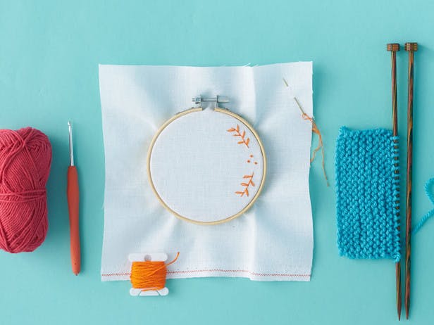 Embroidery hoop with aida and thread floral pattern