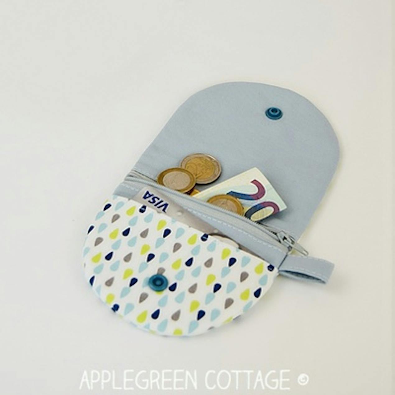sewn coin purse with zip compartment, lined with plastic popper close