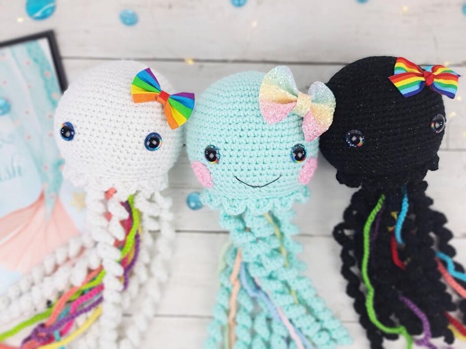 Crochet amigurumi jellyfish with rainbow bows