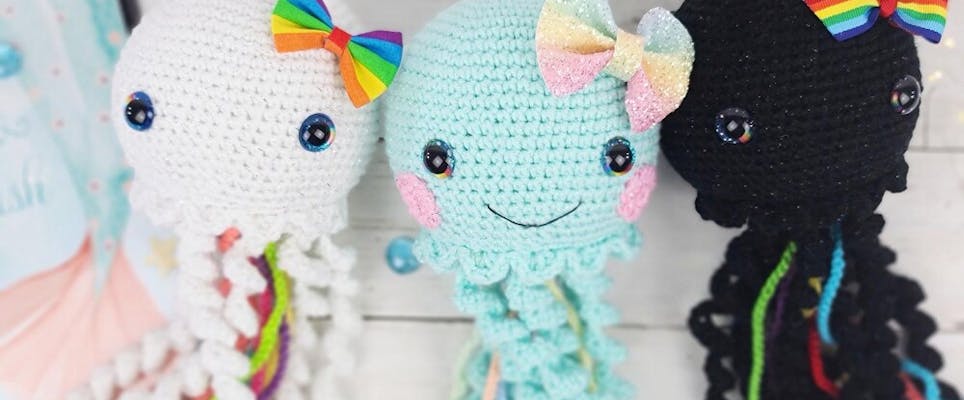 Crochet amigurumi jellyfish with rainbow bows