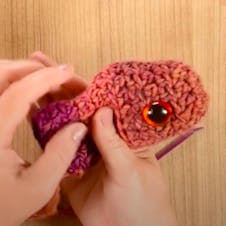 How to crochet a fish - step 5 - sewing on eyes