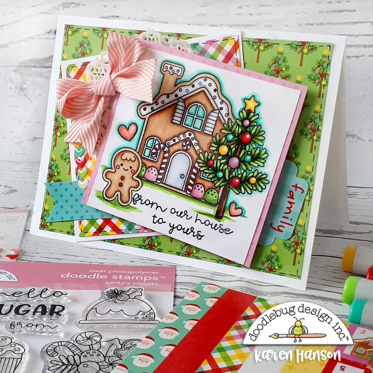 stamped ginger bread house with a tree and gingerbread man. Writing that says "from our hour to yours" 