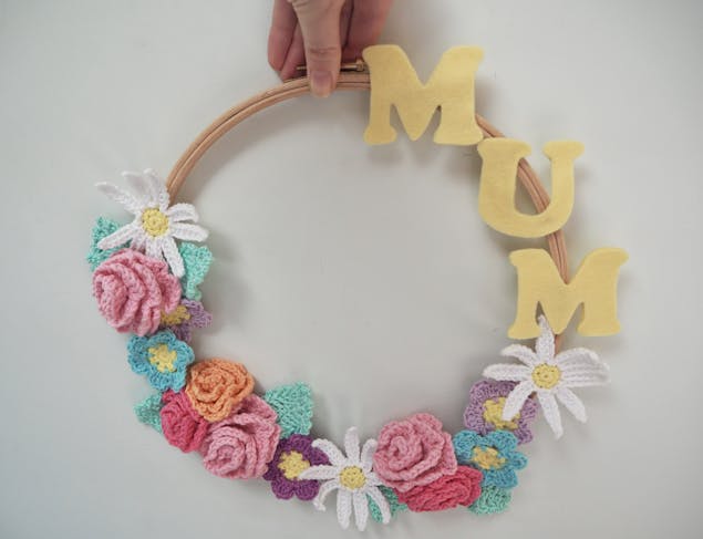 Image of wreath with crochet flowers and mum word.