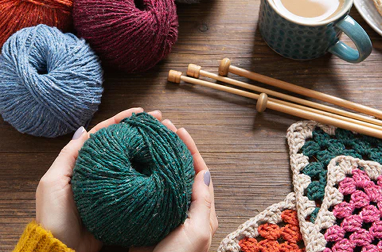 holding a ball of yarn