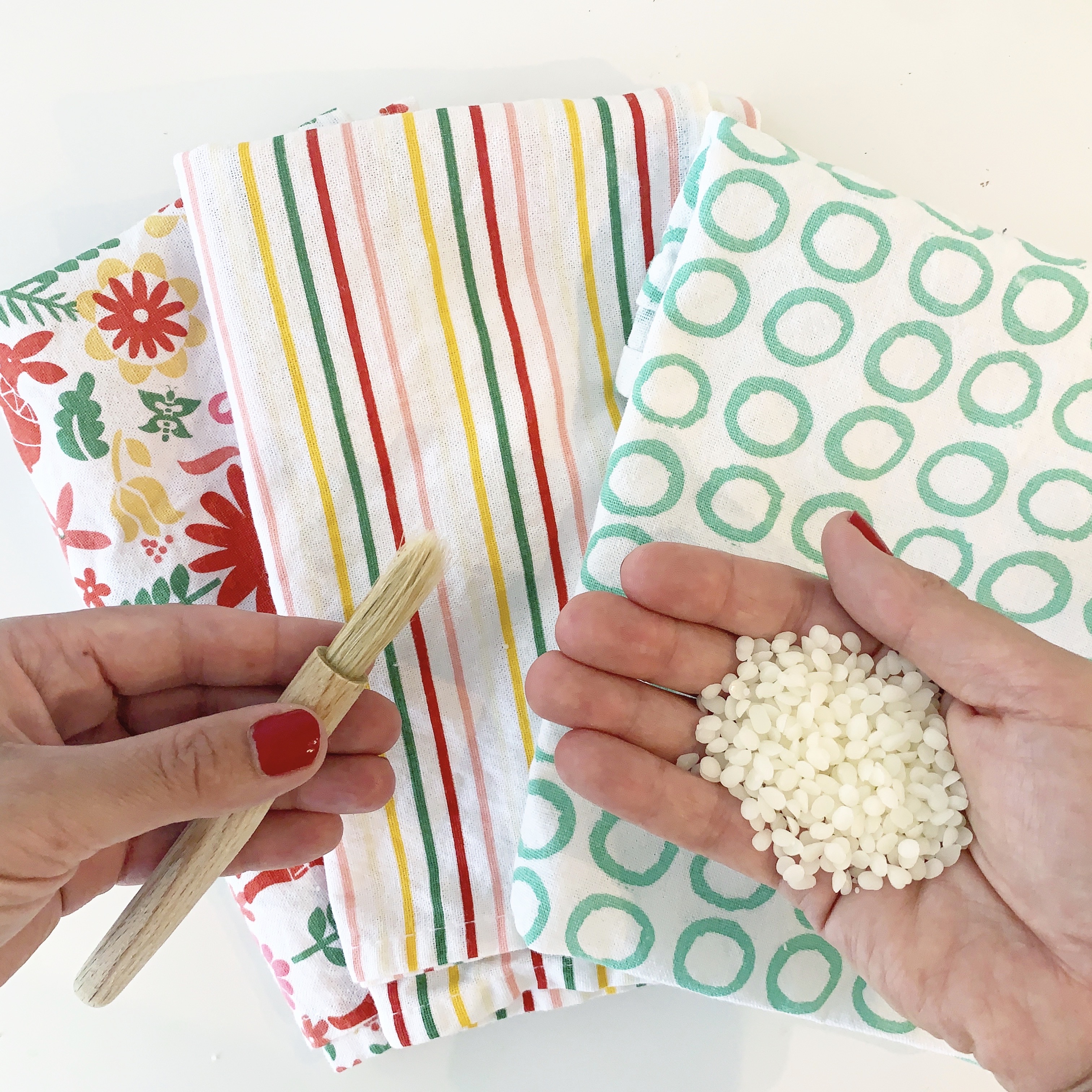 what you need to make your own beeswax food wraps - fabric, paintbrush and beeswax pellets