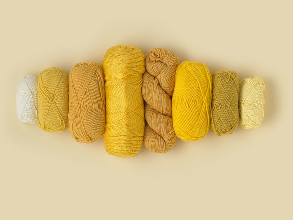 Different weights and fibres of yellow yarn