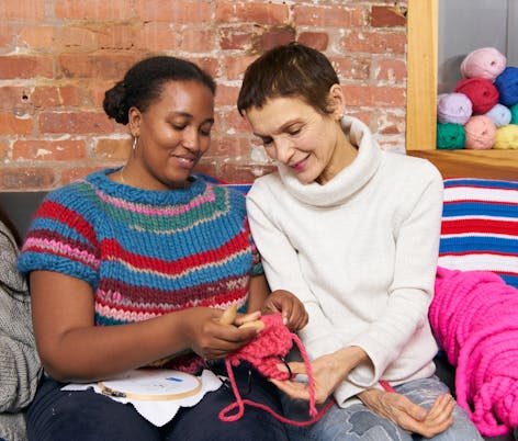 two women knitting for charity 