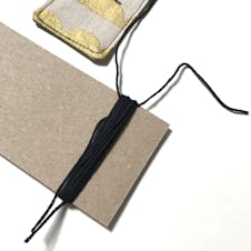 Embroidery thread wrapped around card to make tassel