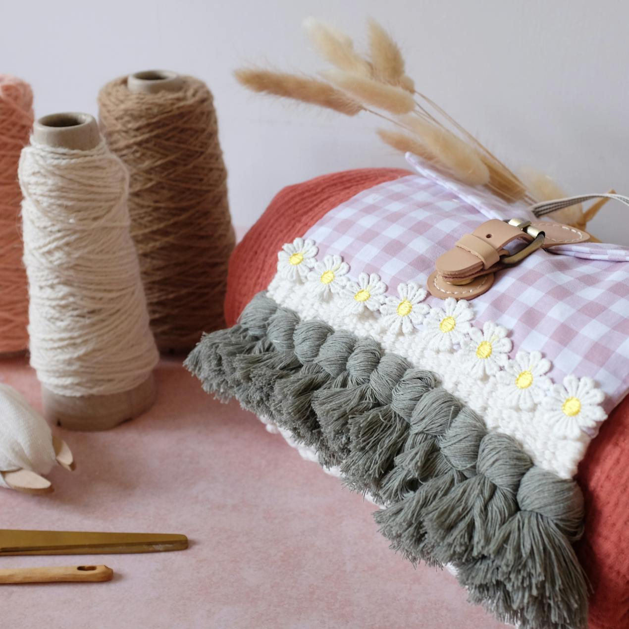 Side view of woven picnic blanket holder, wool cones