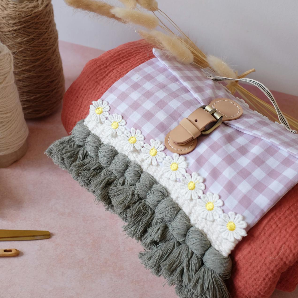 Close up of woven picnic blanket, dried grass