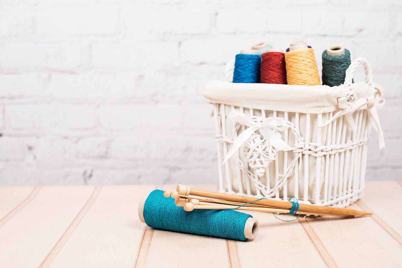 Basket of threads with knitting needleds