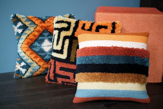 3 latch hook cushions with different colourful patterns